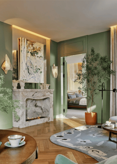 Aesthetic green interior design room with modern art and plants, white marble fireplace