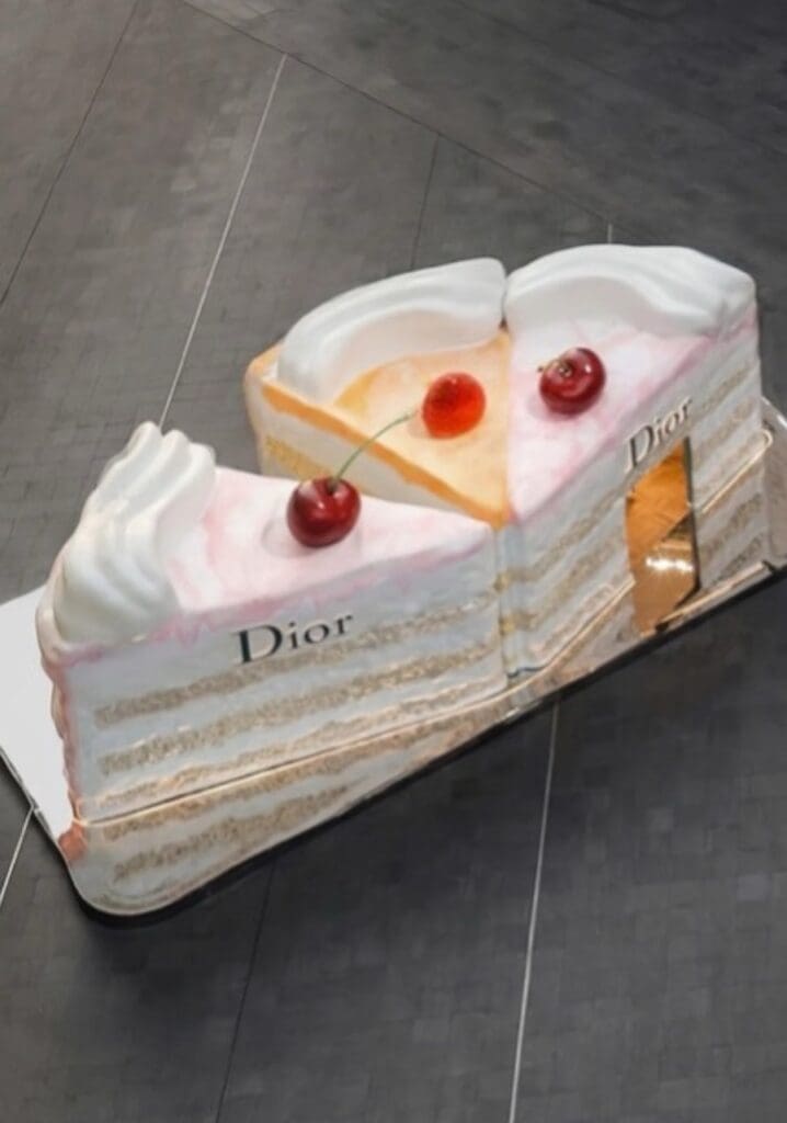 Dior pop up store in China pictured from above, three slices of cake with cherries on top