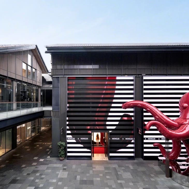 Moncler's "Puffy Summer" giant octopus tentacle showing next to entrance door of the Moncler store in Chengdu